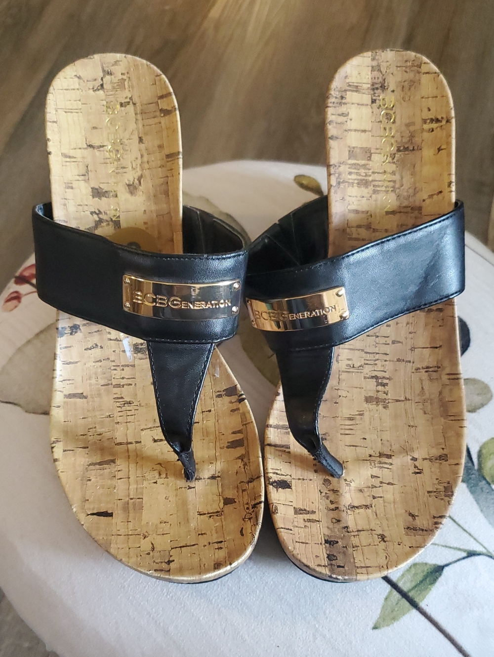 BCBGeneration Black Thong Sandals with Gold Logo Plaques